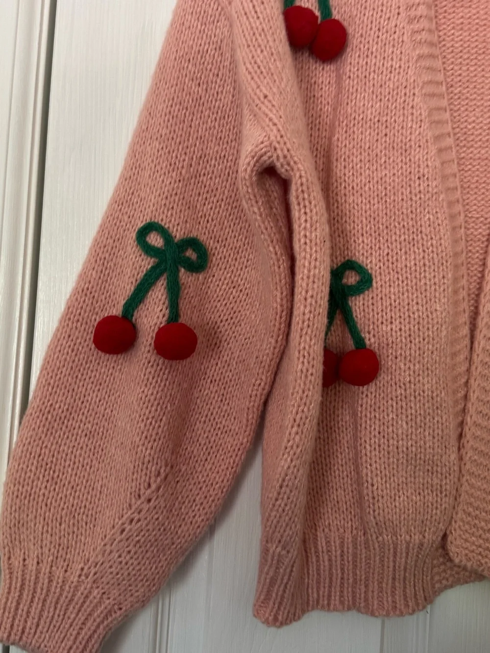 Pink Luna Ivy cardigan featuring prominent green and red 3D cherry appliqués. - Picture 5 of 6